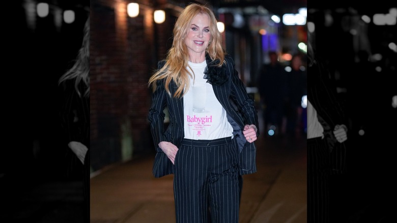 Nicole Kidman pictured in New York after a taping of Stephen Colbert's TV show, wearing a pinstripe suit and a white t-shirt that says "babygirl."