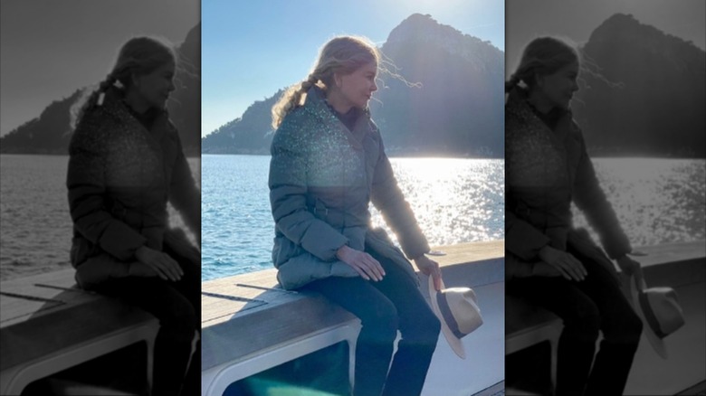 Nicole Kidman pictured on a boat in Mallorca, wearing a thick coat with her curly hair up