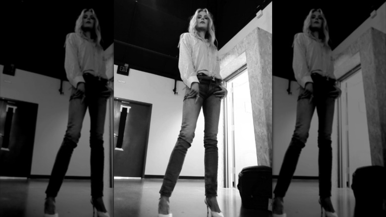 Nicole Kidman in a selfie at the American Film Institute, staring down at the camera as she wears a blouse with a bow, jeans, and high heels