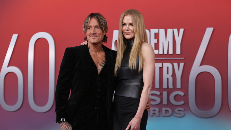 Keith Urban posing with Nicole Kidman on the red carpet in matching all-black outfits