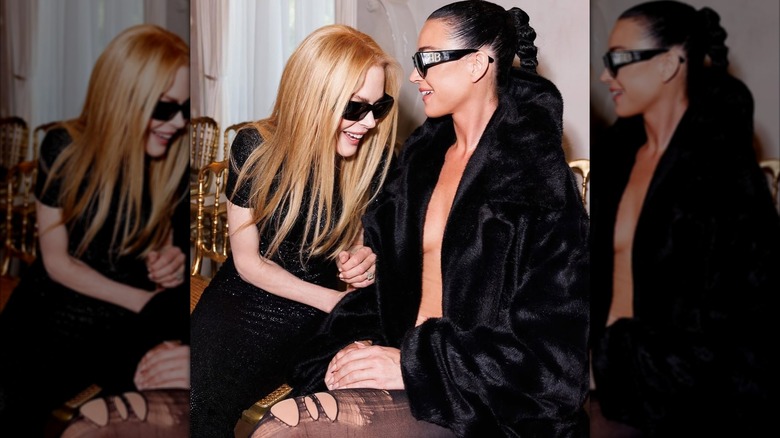 Nicole Kidman laughing next to Katy Perry at a Balenciaga show.