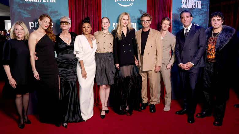 Nicole Kidman and Simon Baker holding hands amidst the "Scarpetta" cast.