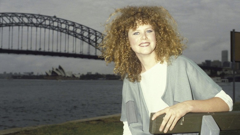 Nicole Kidman smiling in the '90s in Sydney with massive curly red hair