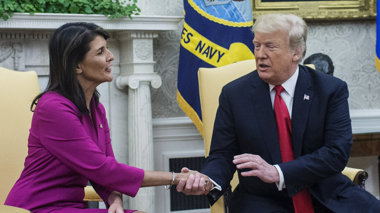 Nikki Haley shaking hands with Donald Trump