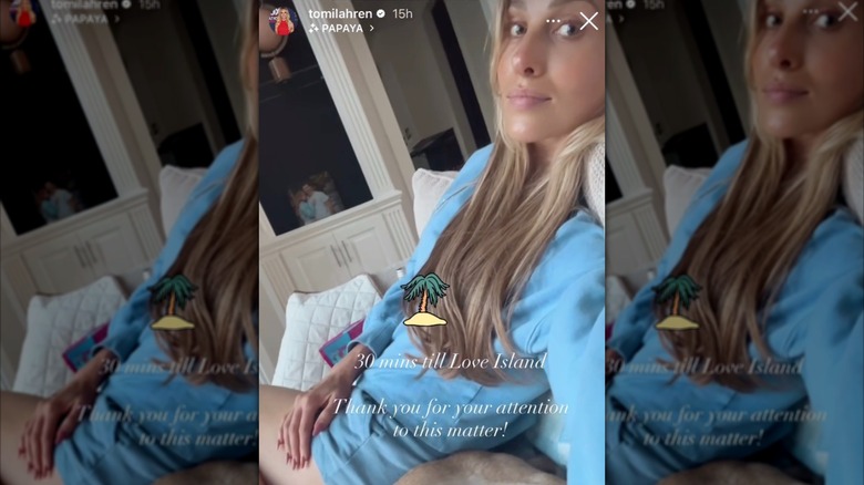 Tomi Lahren smirking while wearing a long-sleeved blue shirt.