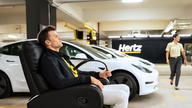 Tom Brady sitting, Limperis walks by in Hertz garage