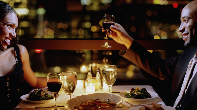 African American couple with wine and dinner