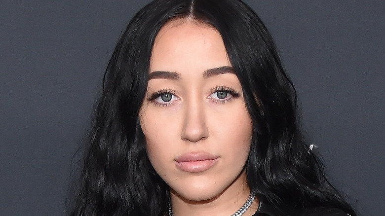 Noah Cyrus poses