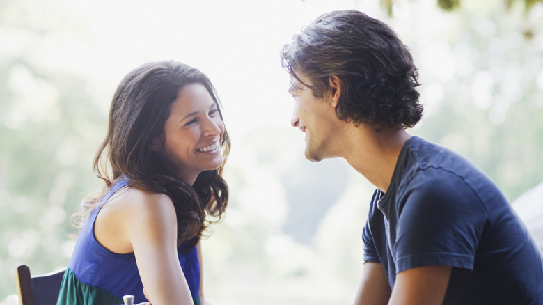 Women, man smiling at each other