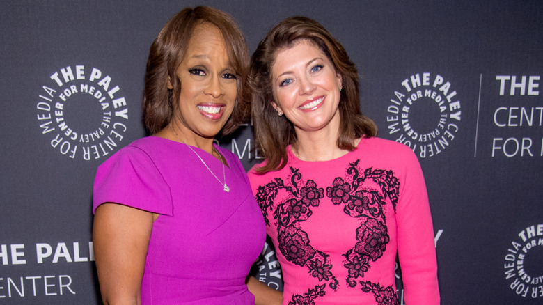 Gayle King and Norah O'Donnell smiling while posing together at a red carpet event