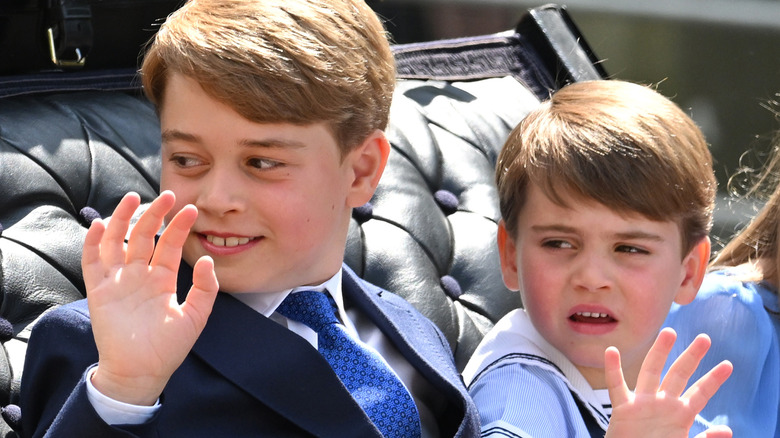 Prince George, Princess Charlotte, and Prince Louis wave from a carriage
