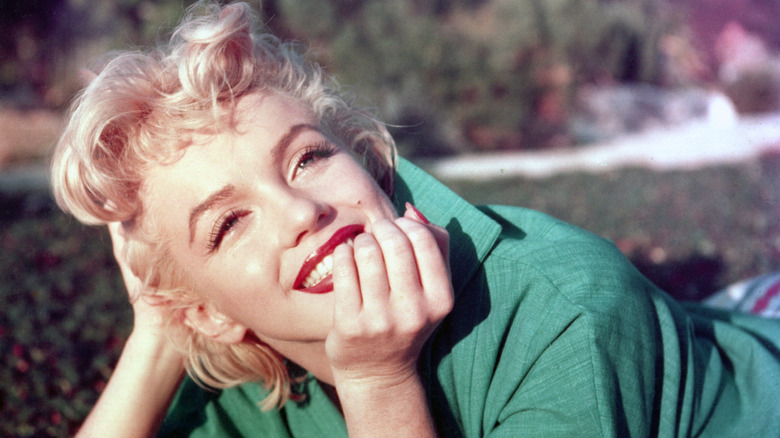 Marilyn Monroe smiling and wearing green