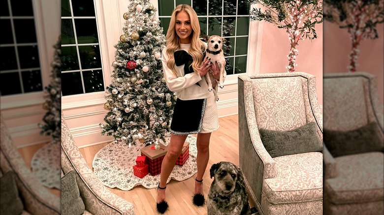 Tomi Lahren smiles as she holds a dog (2024)