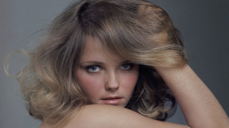 Cheryl Tiegs posing and wearing a pearl necklace.