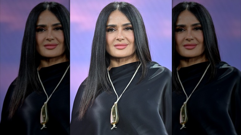 Salma Hayek smiles in a black top