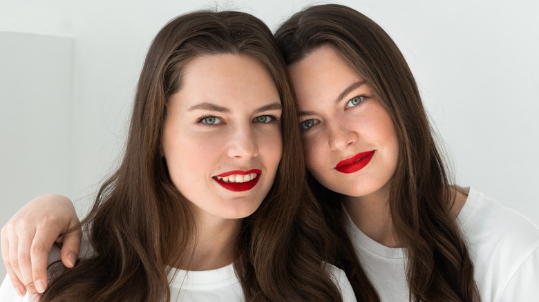 Twins wearing red lipstick