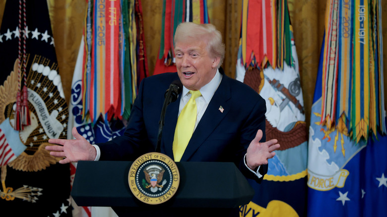Donald Trump grinning as he delivers a speech