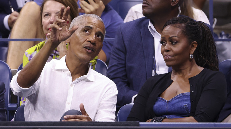 Michelle Obama looking at Barack Obama gesturing