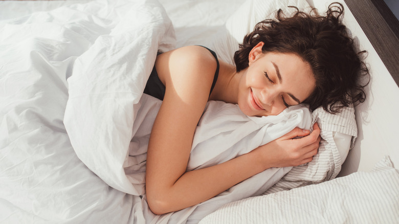 Woman sleeping and smiling