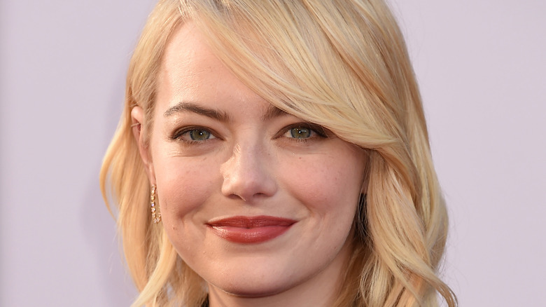 Blonde haired Emma Stone smiling for the camera