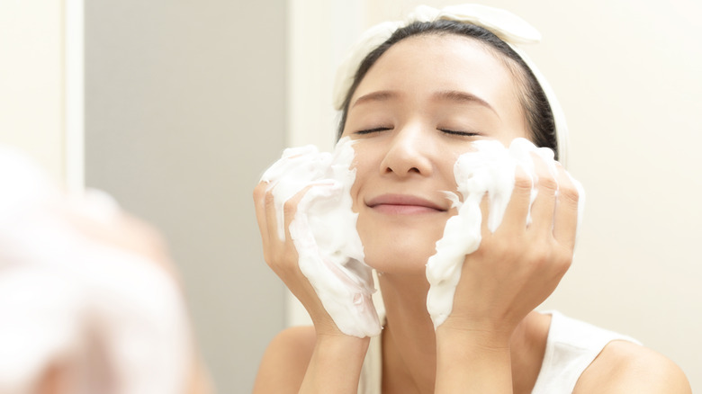 Woman using foaming face wash