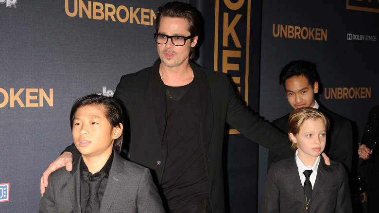 Brad Pitt and his children posing for photos