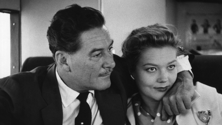 Errol Flynn with his arm around Patrice Wymore