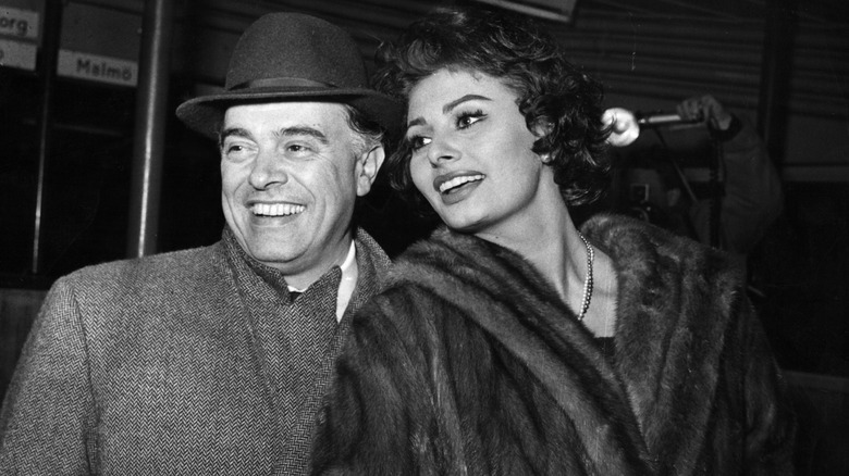 Sophia Loren in a fur coat beside Carlo Ponti