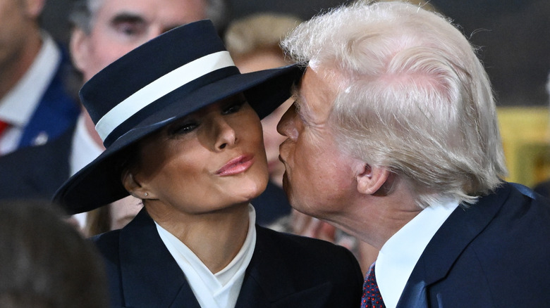 Donald Trump and Melania Trump sharing an air kiss at the 2025 inauguration
