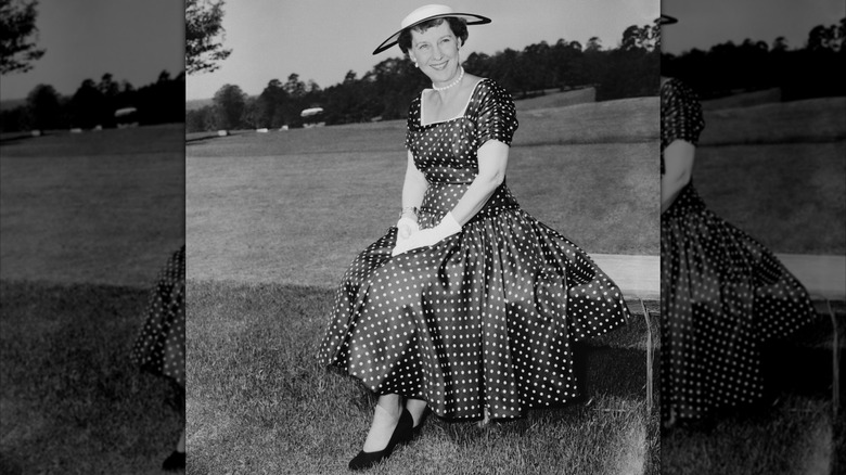 Mamie Eisenhower seated while wearing a black polka dot dress