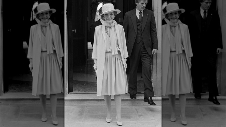 Nancy Reagan smiles while wearing a light monochrome outfit