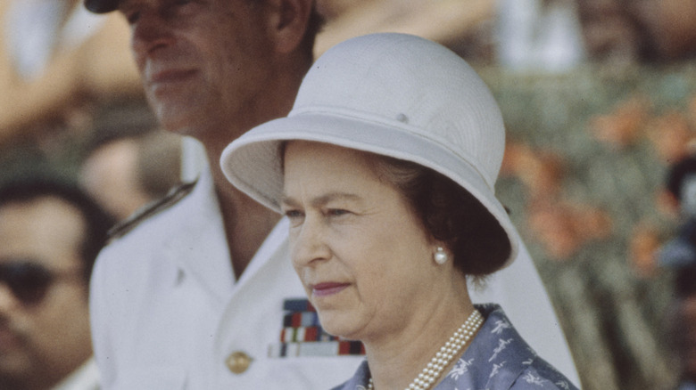 Queen Elizabeth wearing a helmet hat on a 1982 tour of the Soloman Islands