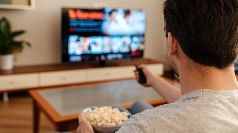 A man watching television. 