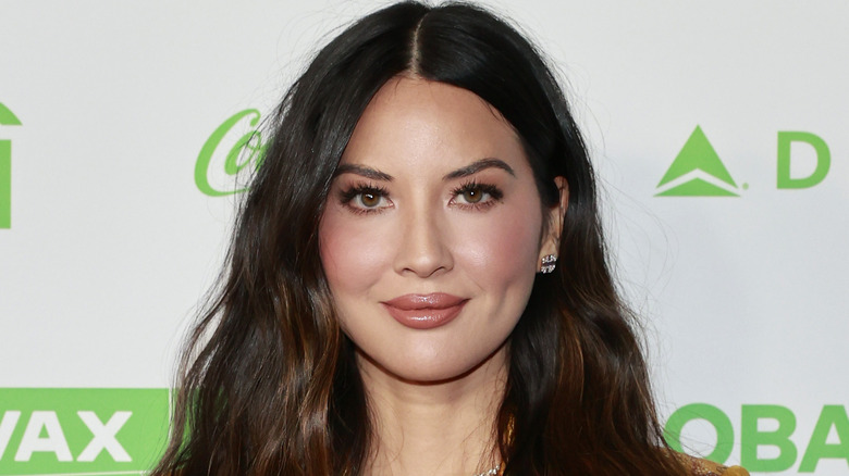 Olivia Munn standing on the red carpet