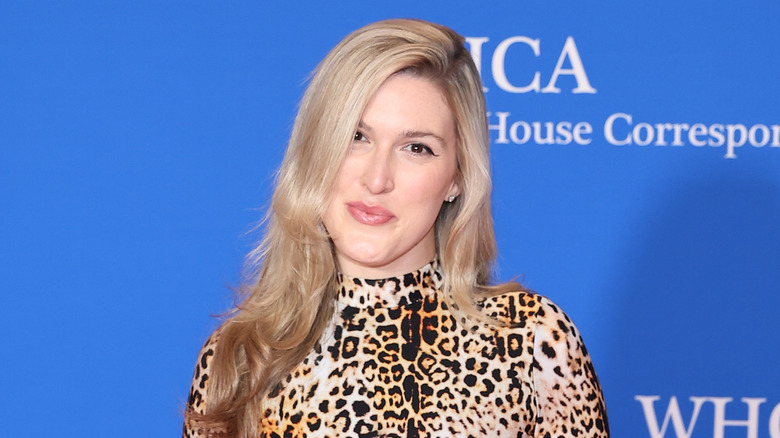 Olivia Nuzzi smiling for photos in a leopard print top