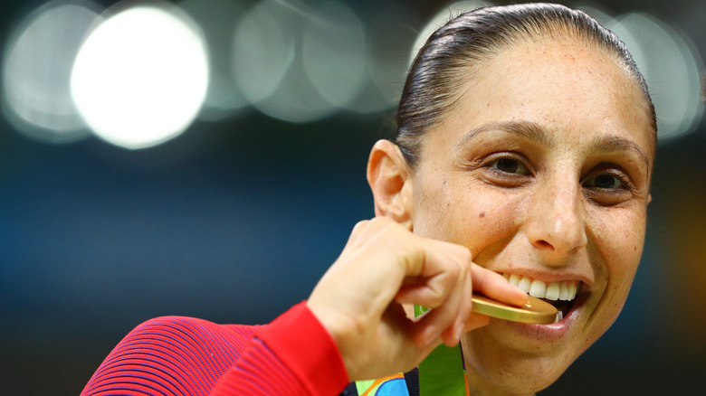 Olympian Diana Taurasi chews on her medal