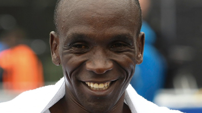 Runner Eliud Kipchoge smiles after competing