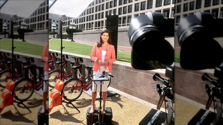 Kaitlan Collins wearing coral