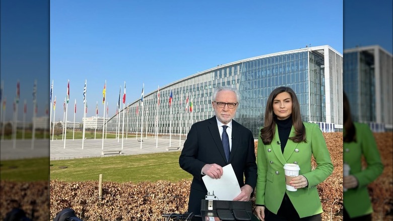 Kaitlan Collins wearing green