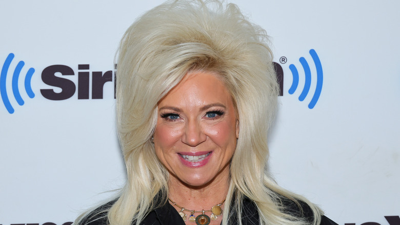 Theresa Caputo with blonde hair, smiling