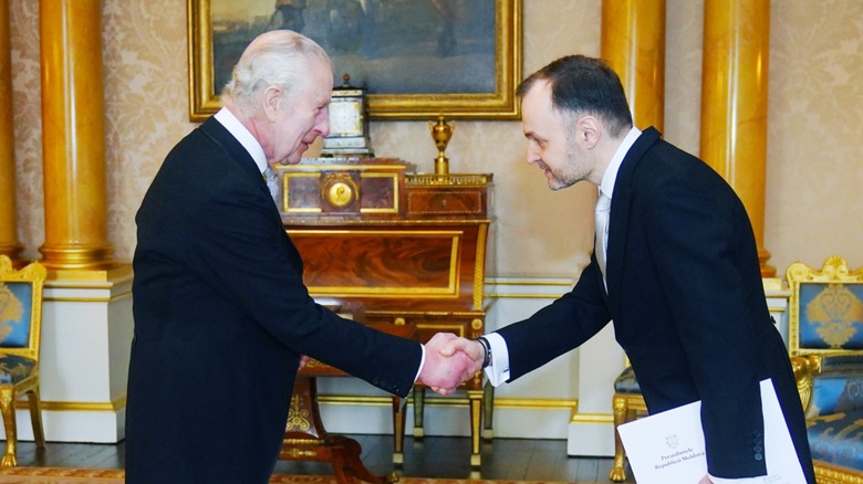 King Charles III and Ruslan Bolbocean shaking hands