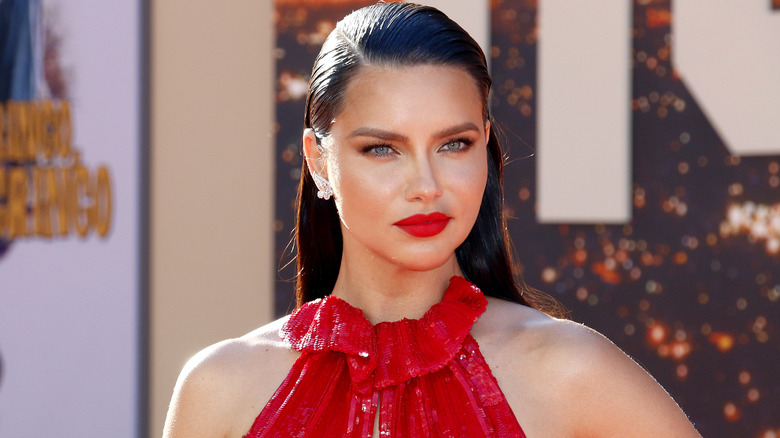 Adriana Lima in red lips and red dress