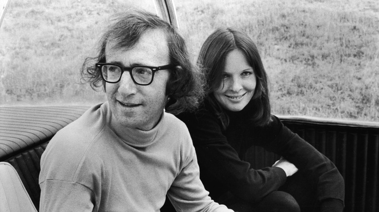 Diane Keaton and Woody Allen smiling in the back seat of a car