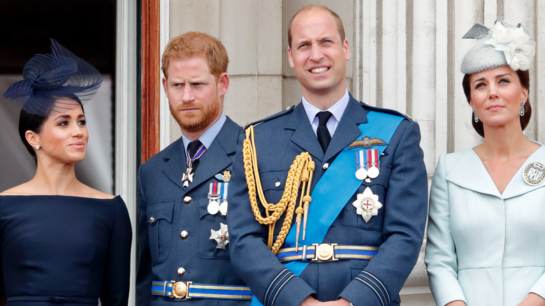 Meghan Markle, Prince Harry, Prince William and Kate Middleton stand awkwardly in their finery