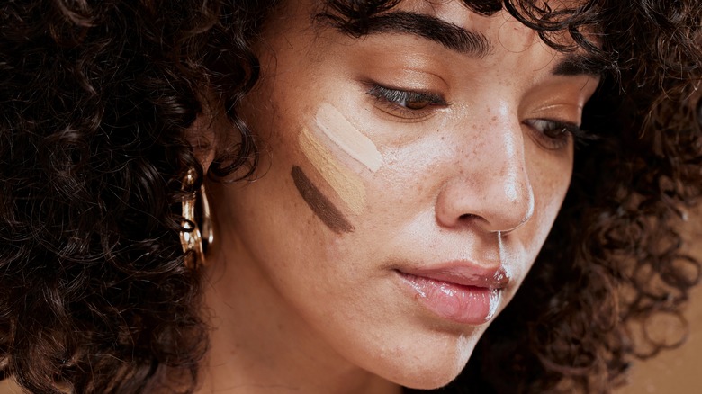 dark skin model testing shades of concealer