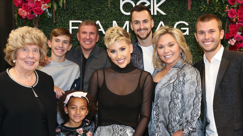 The Chrisley family pose at an event for Savannah Chrisley