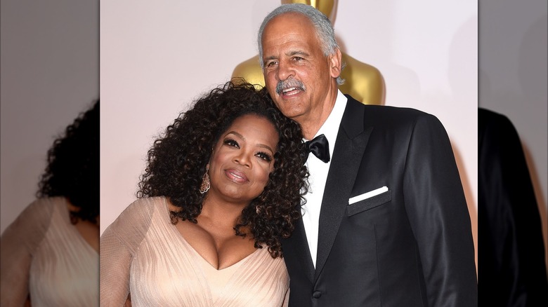 Oprah Winfrey and Stedman Graham leaning against each other