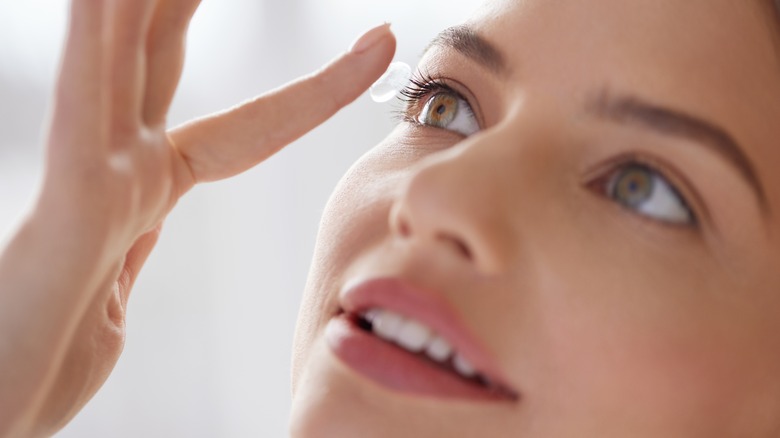 Woman putting contacts in