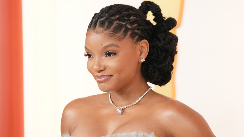 Halle Bailey smiling at the Oscars