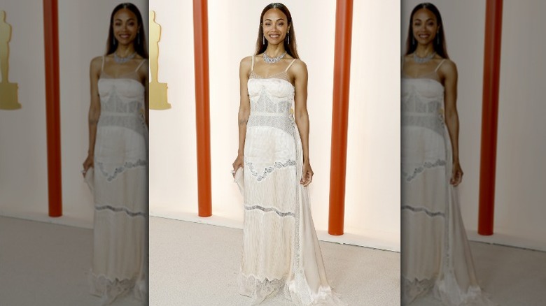 Zoe Saldana smiling on Oscars carpet